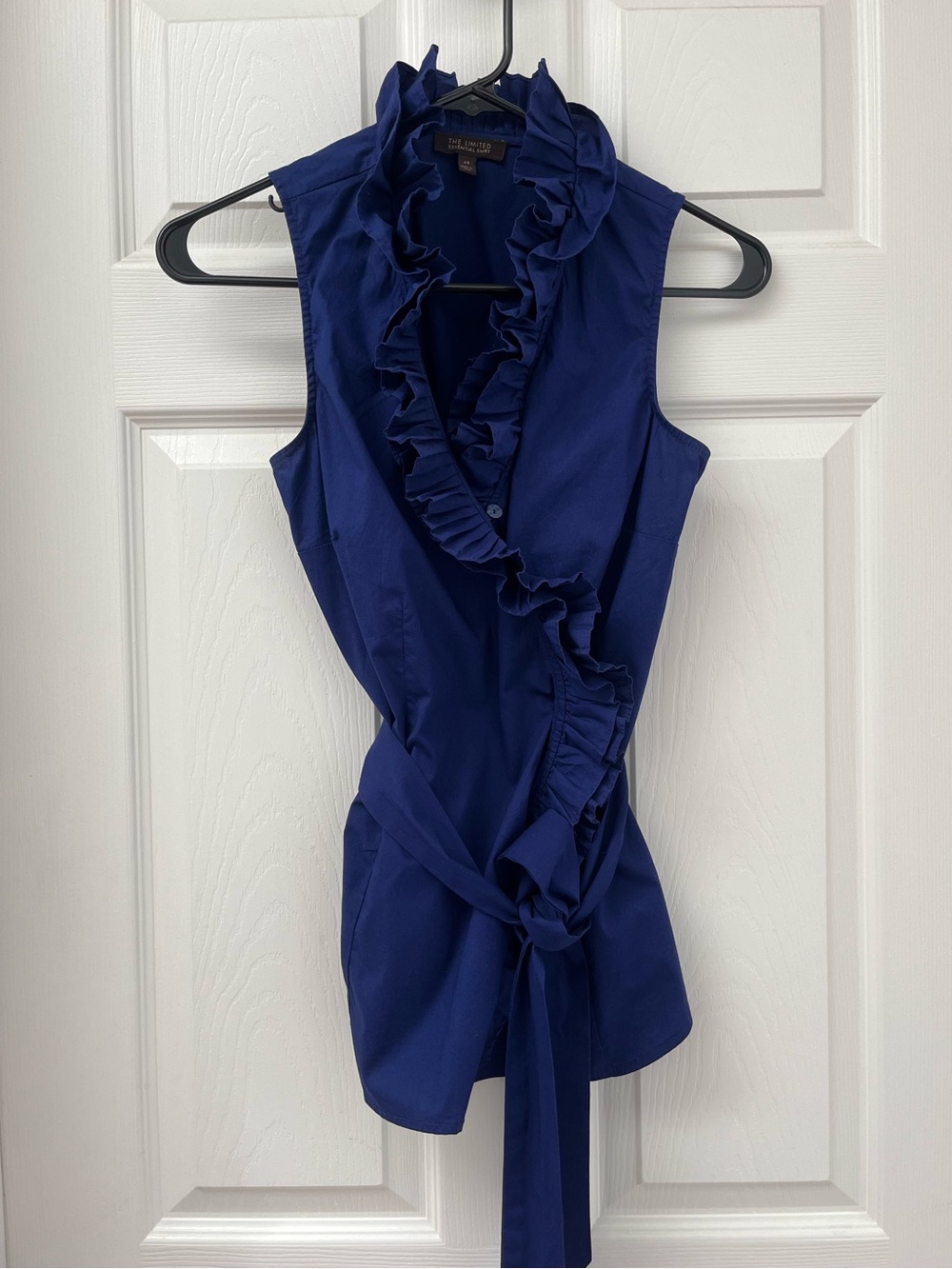 Limited sleeveless ruffle neck wrap blouse